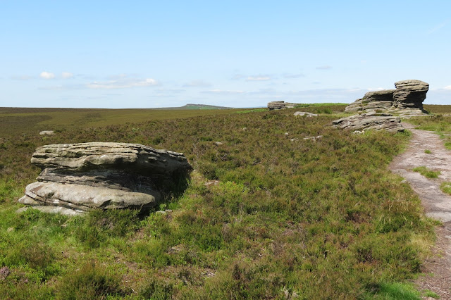 A view across moorland, past the Ox Stones, to the start of Stanage Edge on the horizon.