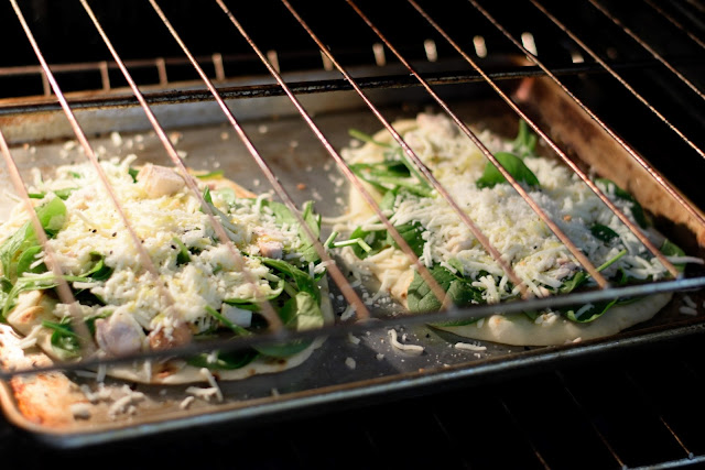 The Chicken and Spinach Naan Bread Pizzas in the oven.