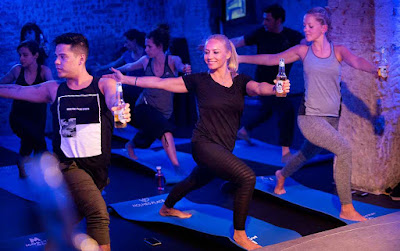 people holding alcoholic drinks in yoga