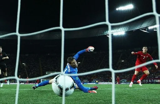 Portuguese winger Cristiano Ronaldo scores the winner past Dutch goalkeeper Maarten Stekelenburg