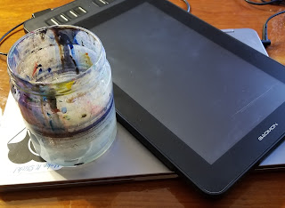 A photograph of a well-used paint-water glass jar sitting beside a Gaomon brand digital tablet.