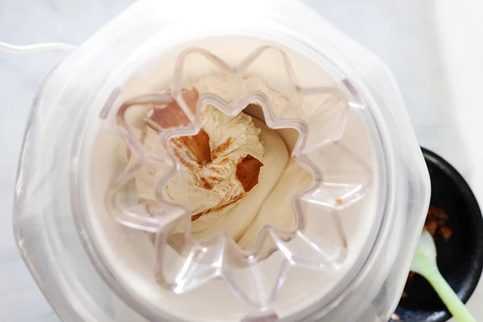 adding apples to churning ice cream