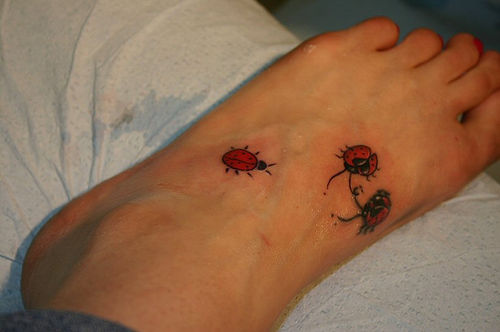 Three ladybug tattoos on foot