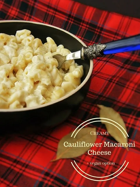 A bowl of Creamy Cauliflower Macaroni Cheese on a red tartan placemat