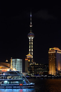 Pearl Tower with tour boat in Shanghai