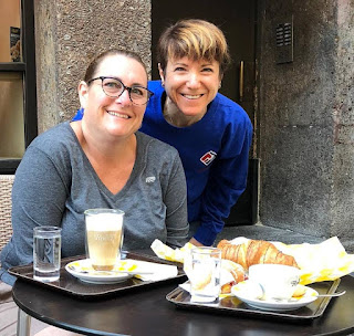 Marla and me outside of a cafe in Austria with a plate of pastries in front of us.