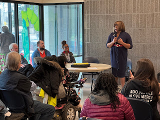 Woman addresses the crowd at Transit Equity Day