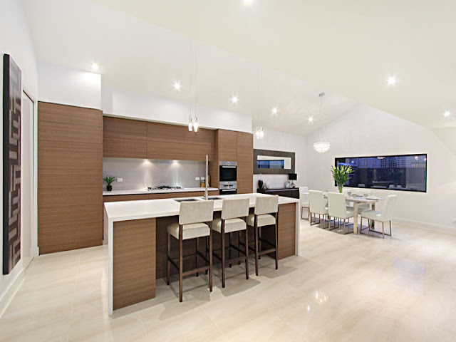 Picture of modern kitchen with brown furniture and kitchen island with three bar chairs