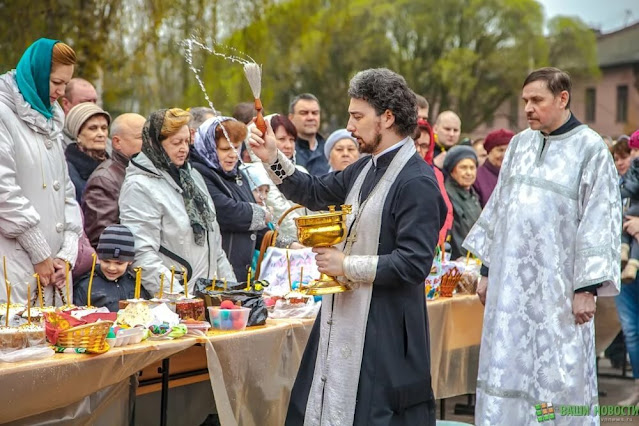 On Saturday, cakes and eggs are brought to the church for consecration - the priest watered with holy water.