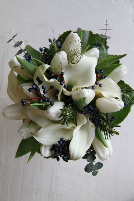 White Calla Lilies Tulips are combined along with lovely winter foliages