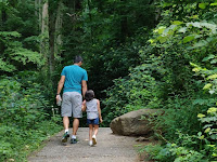 Daughter and father on the way to explore the nature