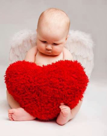 baby with heart pillow wallpaper