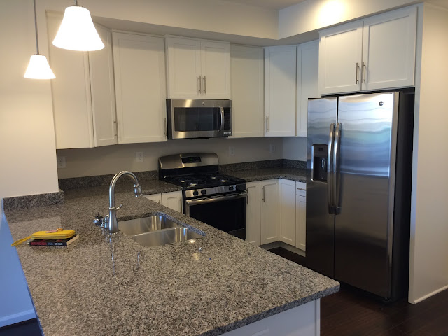 White Sonoma cabinets and New Caledonia granite kitchen