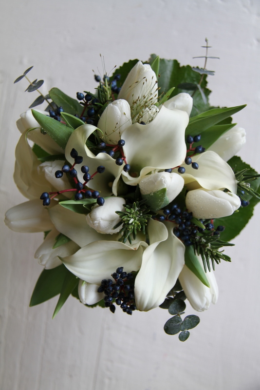 White Calla Lilies Tulips are combined along with lovely winter foliages 