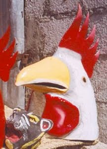 Papier mache masks, a rooster and a cat.