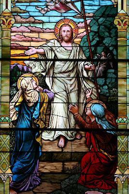 Stained Glass window with the resurected Christ greeting Mary Magdelay and Mary mother of James outside the tomb.