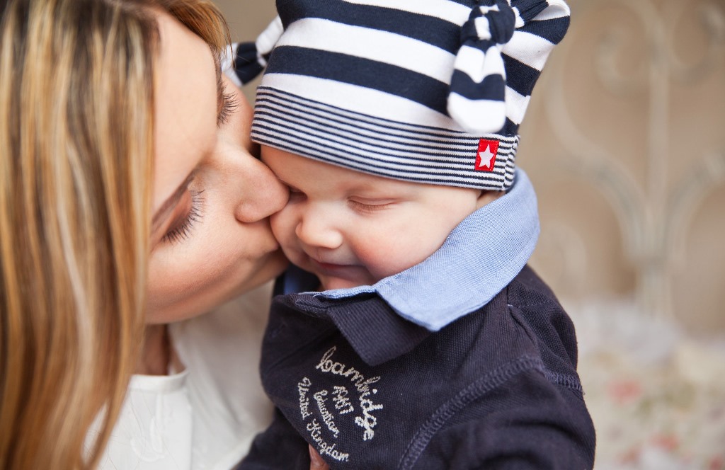 namc studying montessori today lillard ch 2 primary years mother kissing baby on cheek