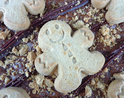 A gingerbread figure atop chocolate and spiced brownies
