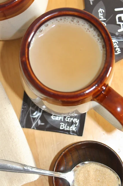 Earl grey tea latte with a spoon of sugar.