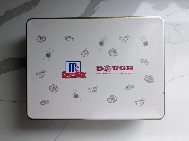 McCormick x Dough Holiday Donut Bites collectible tin with lid on.