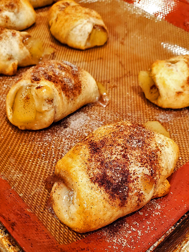 refrigerated crescent roll dough made into a dessert rolled up with apple pie filling