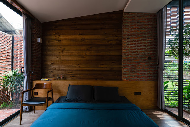 mix of brick and wood paneling at head of bed