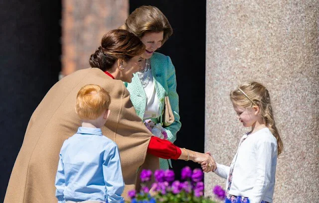 Queen Mary wore a red silk dress by Raquel Diniz, Crown Princess Victoria wore a pink cady dress by Roland Mouret Princess Sofia