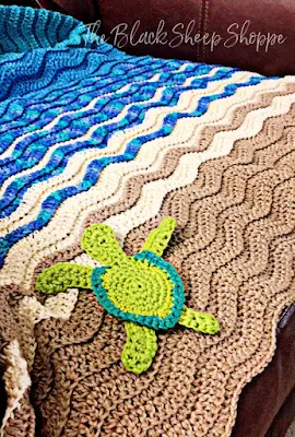 For a more beachy feel I added crocheted sea turtle appliques to the blanket!