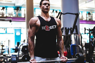 Man focusing hard during a bicep curl