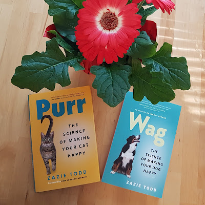 A copy each of Purr and Wag, books by Zazie Todd, and a red gazania