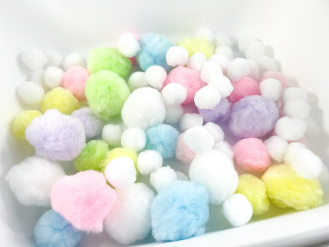 pastel colored craft pom poms.