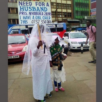 Kenyan Woman Walks the Street of Nairobi with a Placard Stating that She Needs a Husband