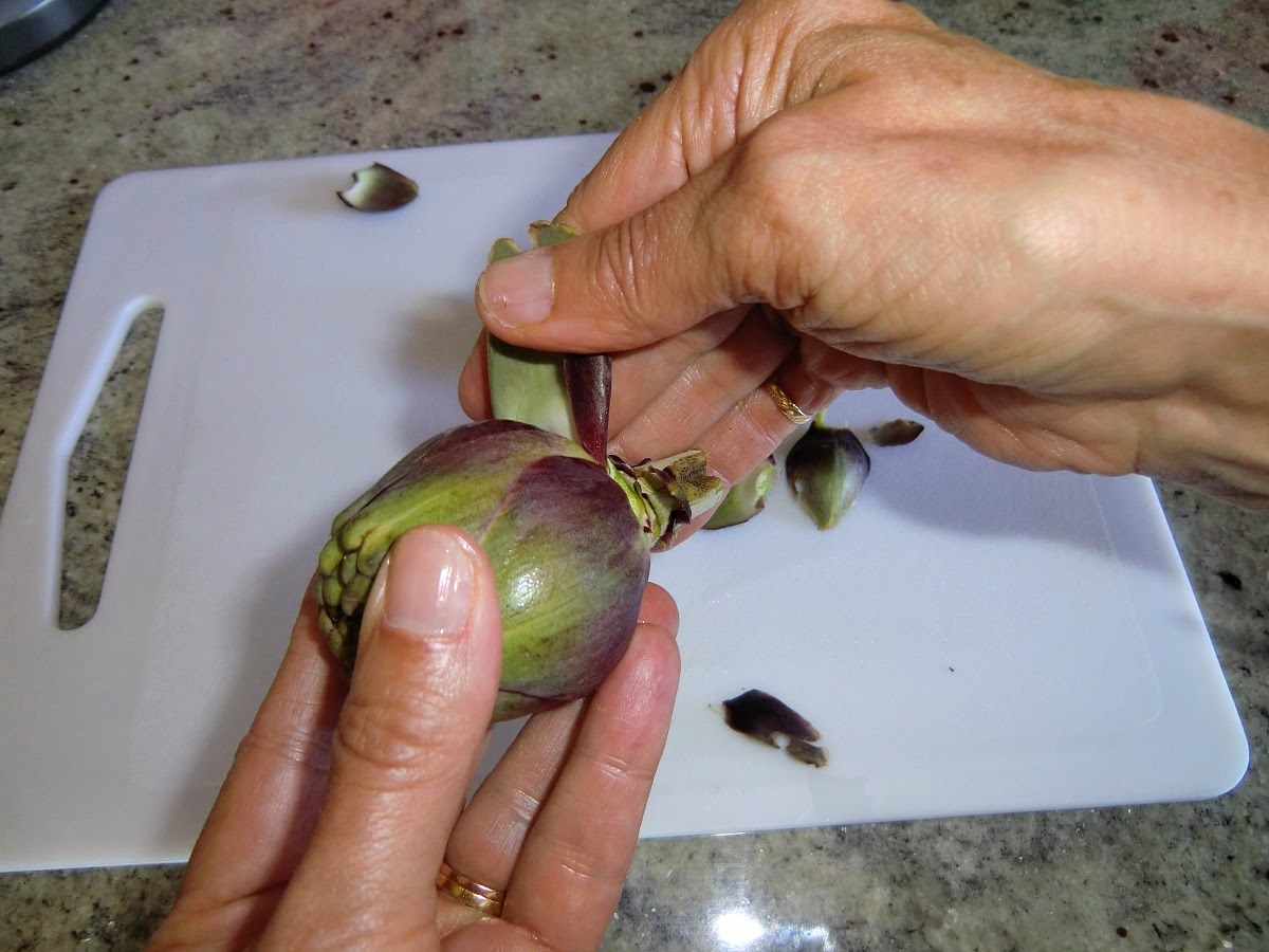 Pull off and discard the tough outer leaves of the artichoke