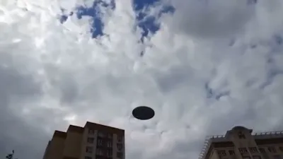 Glass allows people to see UFO above Russian apartment block.
