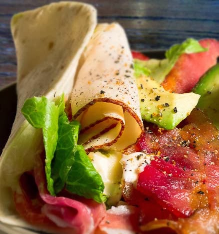 Chicken Wrap with Sliced Chicken Breast, Bacon, Tomato, Avocado, and More.