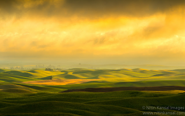 Stormy Sunset light over rolling hills