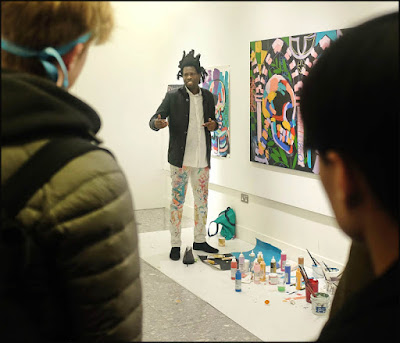 Bradley Theodore talking to some student artists