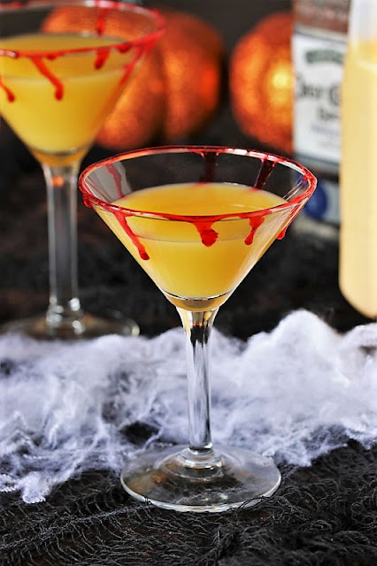 Orange Juice in Martini Glass to Make Bloody Sunrise Halloween Cocktail Image