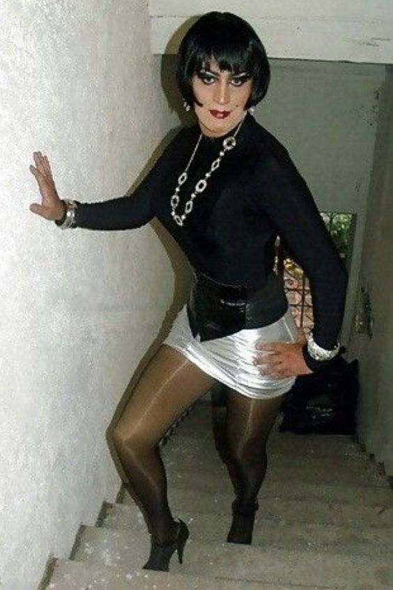 Mature crossdresser in mini skirt and shiny black pantyhose