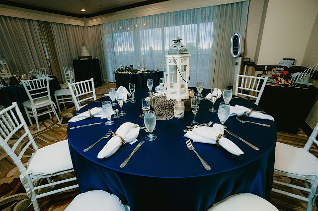 Reception Detail shot of blue table clothed tables with white chairs