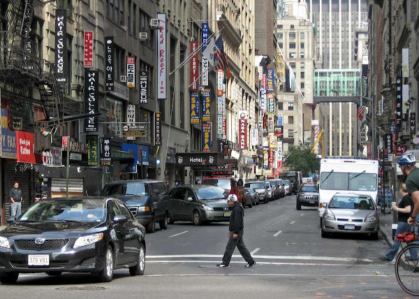 W 32nd St. - Vertical signs, vertical arms, at 5th Ave.