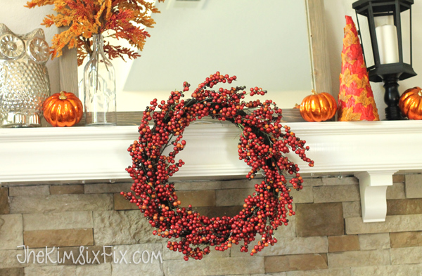 If your mantel shelf is shallow, you can hang a wreath across the front of it, adding depth and drawing the eye towards the center intstead of only above the top of the shelf. 