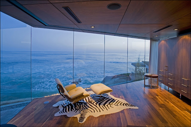 Picture of modern white chair by the glass wall overlooking the ocean