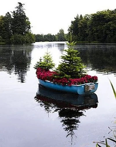 Pot tanaman dari perahu bekas dipajang di danau lebih menarik karena sesuai dengan fungsi perahu kayu.