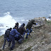 A dinghy carrying migrants hit rocks in Greece, killing 2 people in high winds