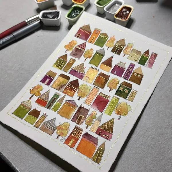 watercolor painting of rows of tiny trees and whimsical houses in autumn tones with golden accents
