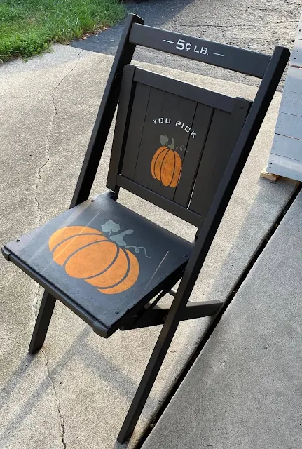 Photo of a wooden folding chair painted and stenciled as fall decor