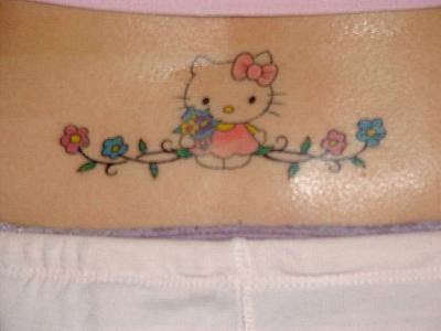 Hello Kitty lower back tattoo with flowers.