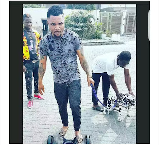 Oritsefemi On A Hoverboard with his Cute Dalmatian Dog(Photo)