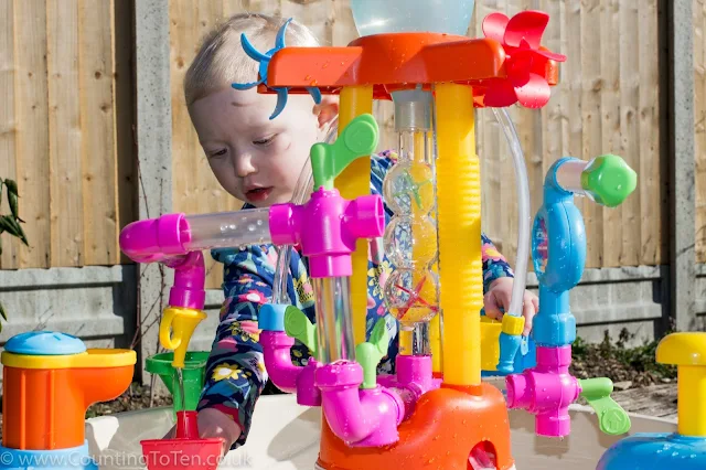 A side view of the Little Tikes Fountain Factory Water Table showing lots of colourful and clear tubing